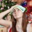 13250632 – woman in christmas hat having hangover at home